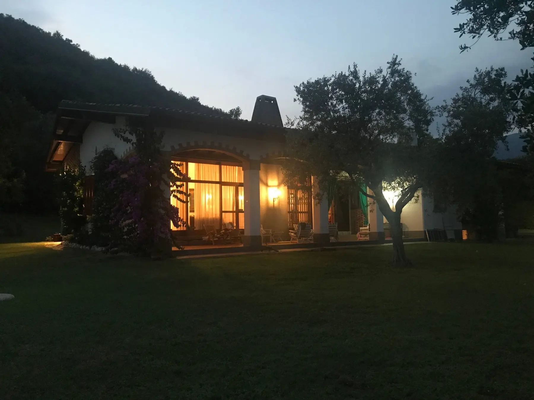 The villa lit up at night